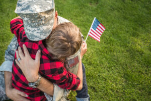 Happy reunion of soldier with family outdoors